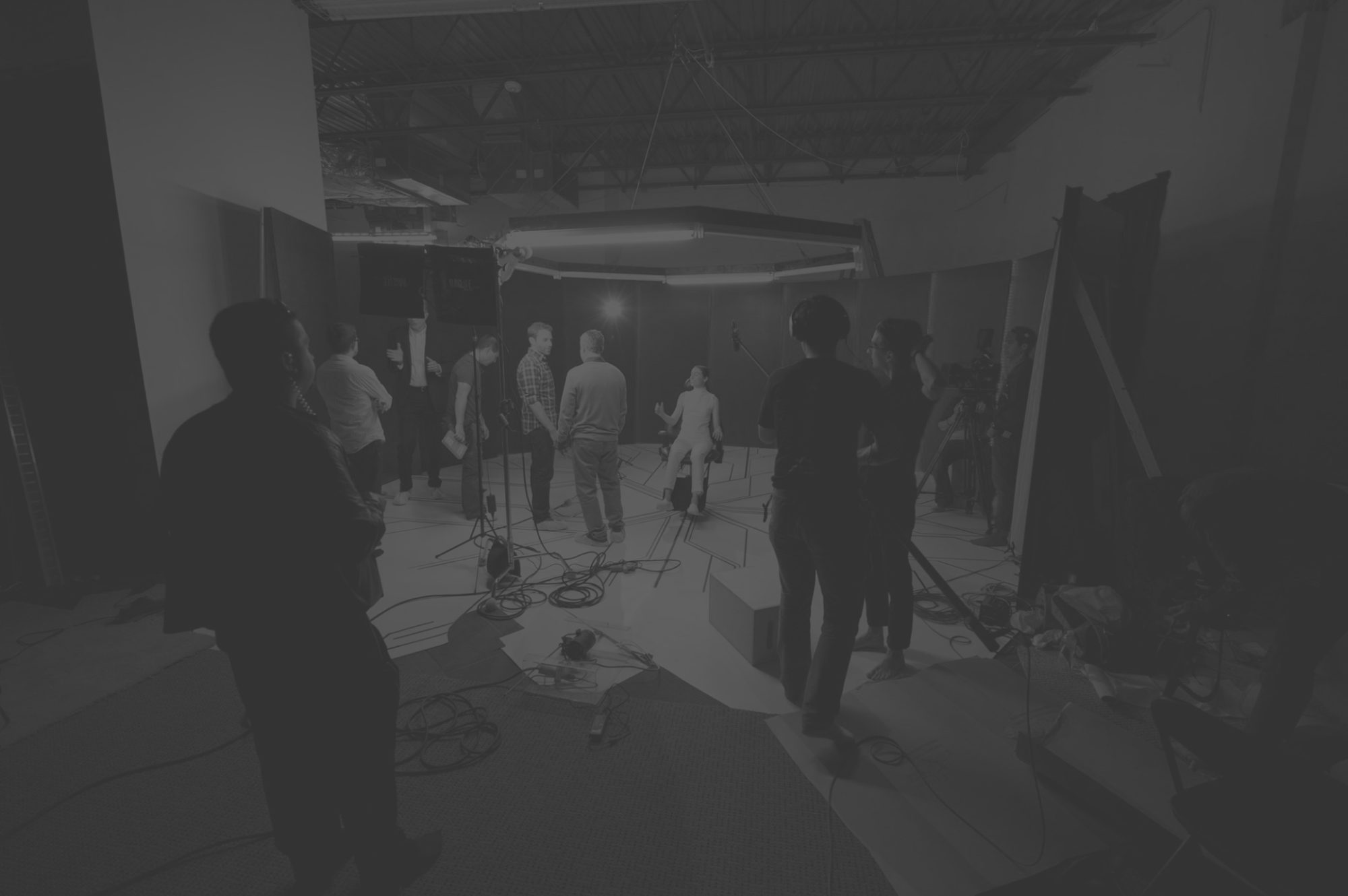 A darkened background photo of the behind the scenes experience of AMELIA 2.0 by Vancouver-based video production company DreamCity Cinema.